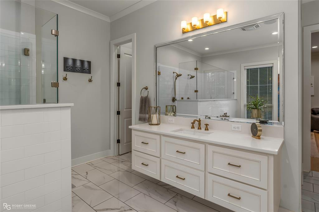 145 Crouch Road Benton, LA 71006 - Photo 17 of 40 a bathroom with a double vanity sink a mirror a shower and a bathtub