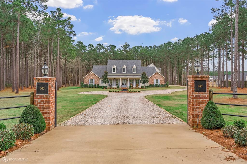 145 Crouch Road Benton, LA 71006 - Photo 2 of 40 a view of a house with a yard potted plants and a large tree