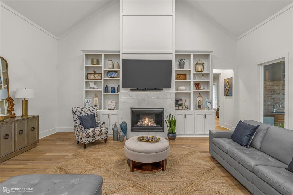 145 Crouch Road Benton, LA 71006 - Photo 22 of 40 a living room with furniture a flat screen tv and a fireplace