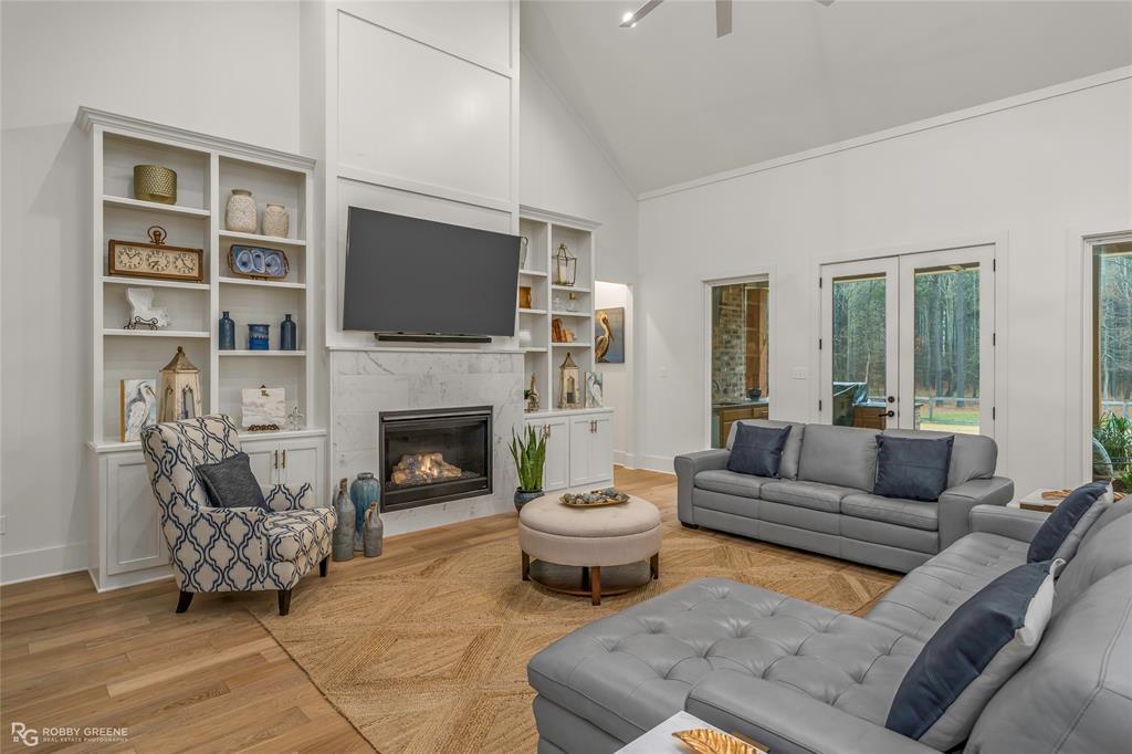 145 Crouch Road Benton, LA 71006 - Photo 23 of 40 a living room with furniture a flat screen tv and a fireplace