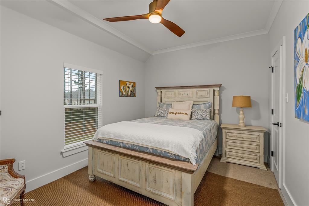 145 Crouch Road Benton, LA 71006 - Photo 36 of 40 a bedroom with a bed and a chandelier