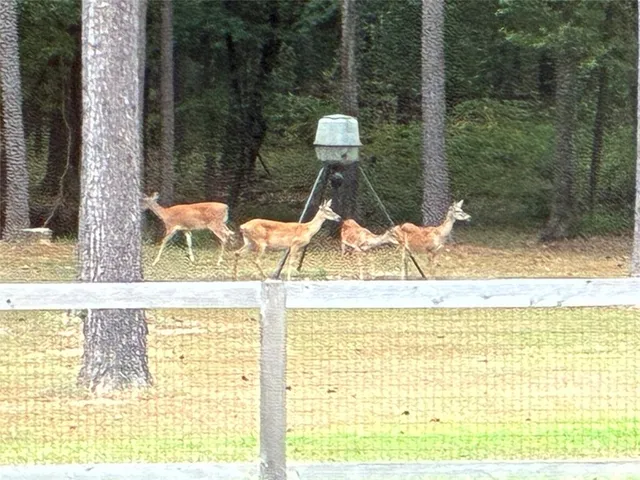 a kitchen with kitchen island granite countertop a stove a sink a dining table and chairs