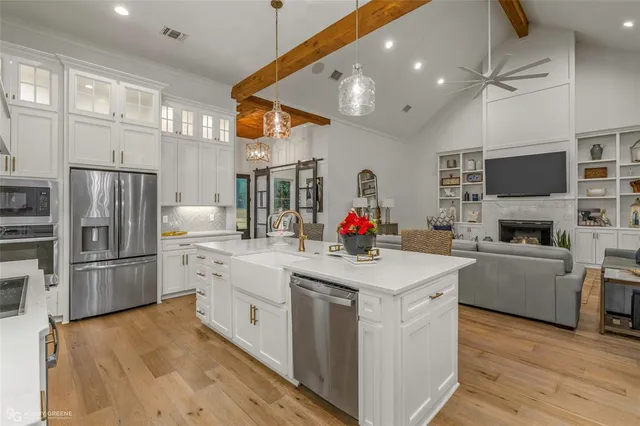 a view of a dining room with furniture a chandelier and wooden floor