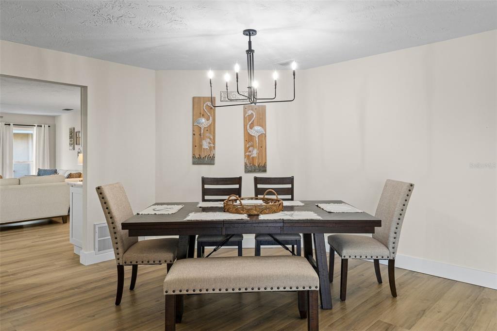 4968 South Shore Drive New Port Richey, FL 34652 - Photo 18 of 60 a view of a dining room with furniture window and wooden floor
