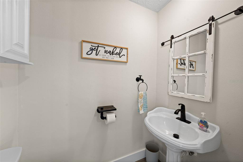 4968 South Shore Drive New Port Richey, FL 34652 - Photo 19 of 60 a bathroom with a sink and mirror