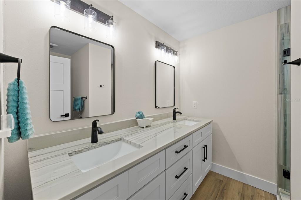 4968 South Shore Drive New Port Richey, FL 34652 - Photo 23 of 60 a bathroom with double vanity sink and a mirror