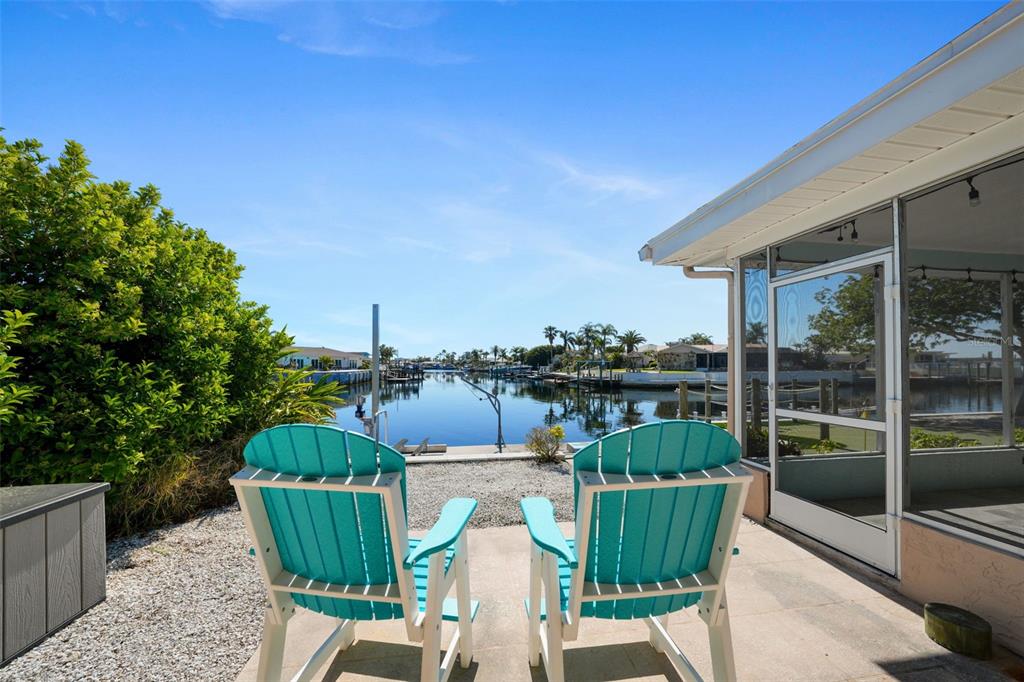 4968 South Shore Drive New Port Richey, FL 34652 - Photo 25 of 60 a view of a chair and tables in the balcony