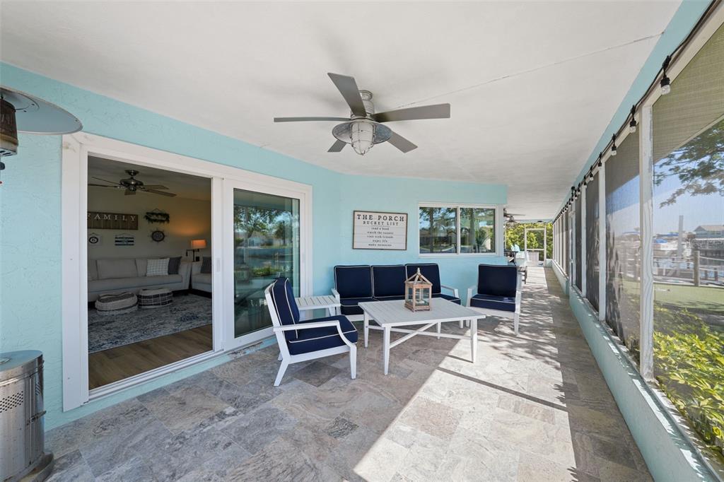 4968 South Shore Drive New Port Richey, FL 34652 - Photo 32 of 60 a living room with furniture a lamp and a floor to ceiling window