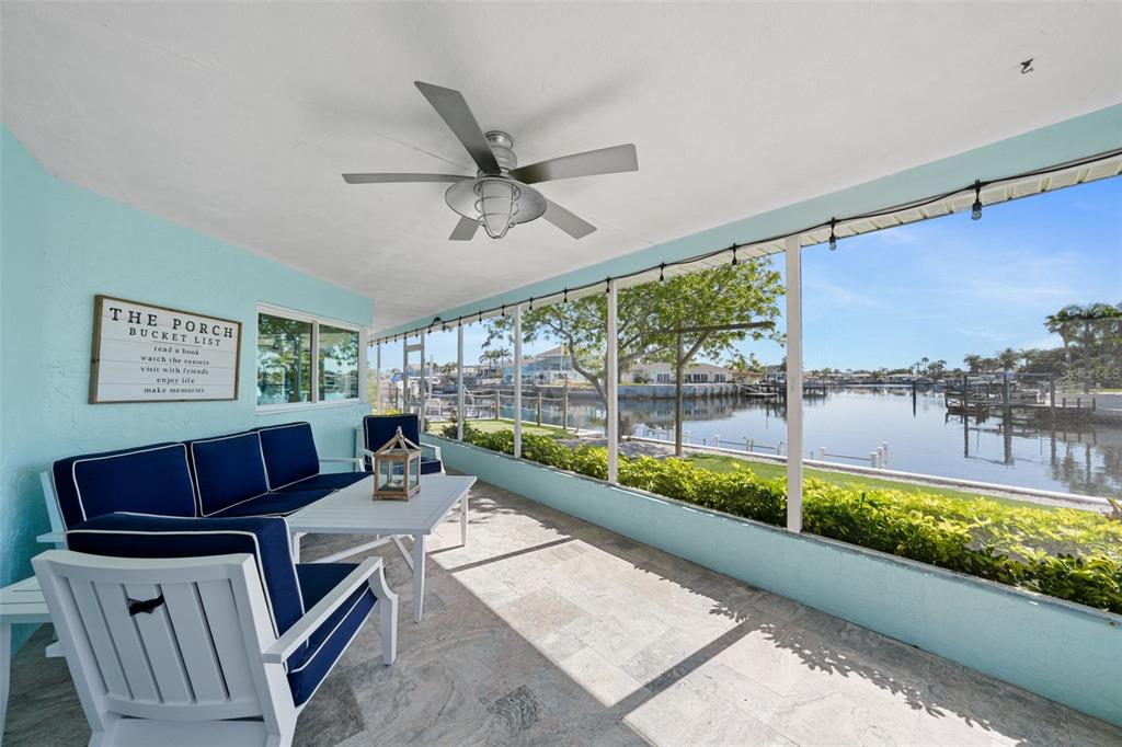 4968 South Shore Drive New Port Richey, FL 34652 - Photo 33 of 60 a living room with furniture and a floor to ceiling window