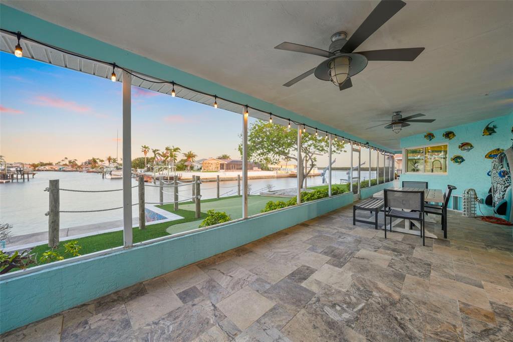 4968 South Shore Drive New Port Richey, FL 34652 - Photo 40 of 60 a view of a porch with furniture and garden view