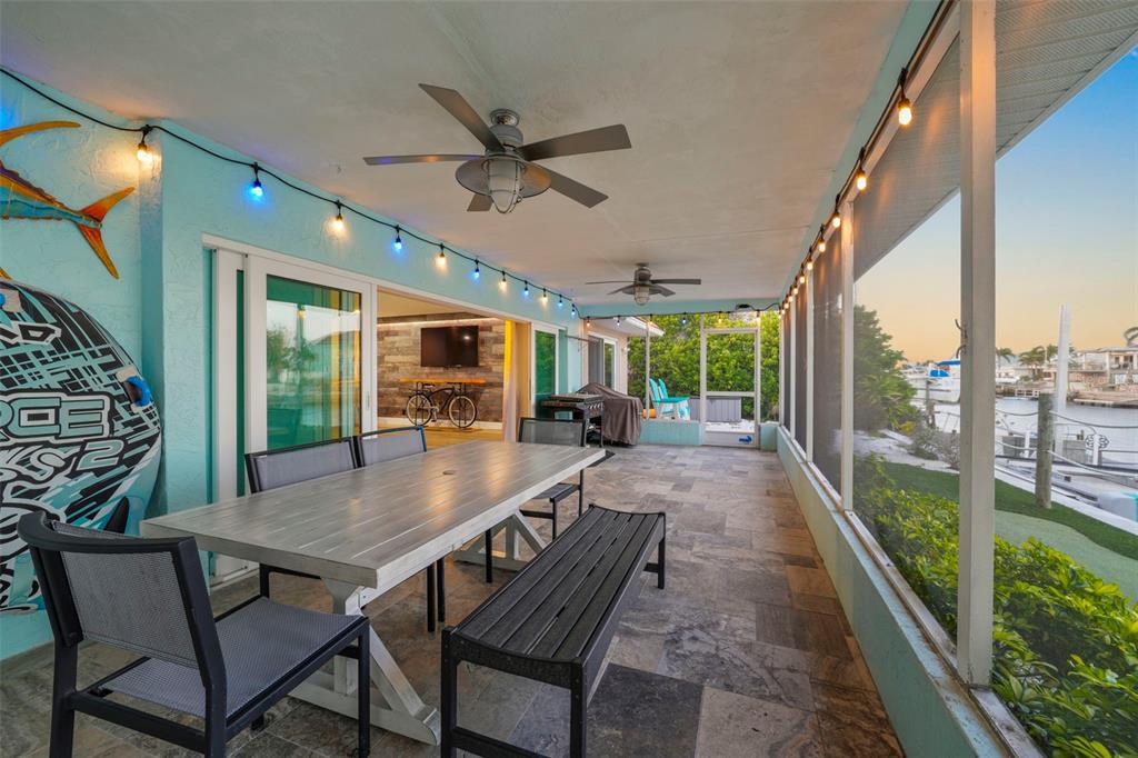 4968 South Shore Drive New Port Richey, FL 34652 - Photo 41 of 60 a view of a porch with furniture and a yard