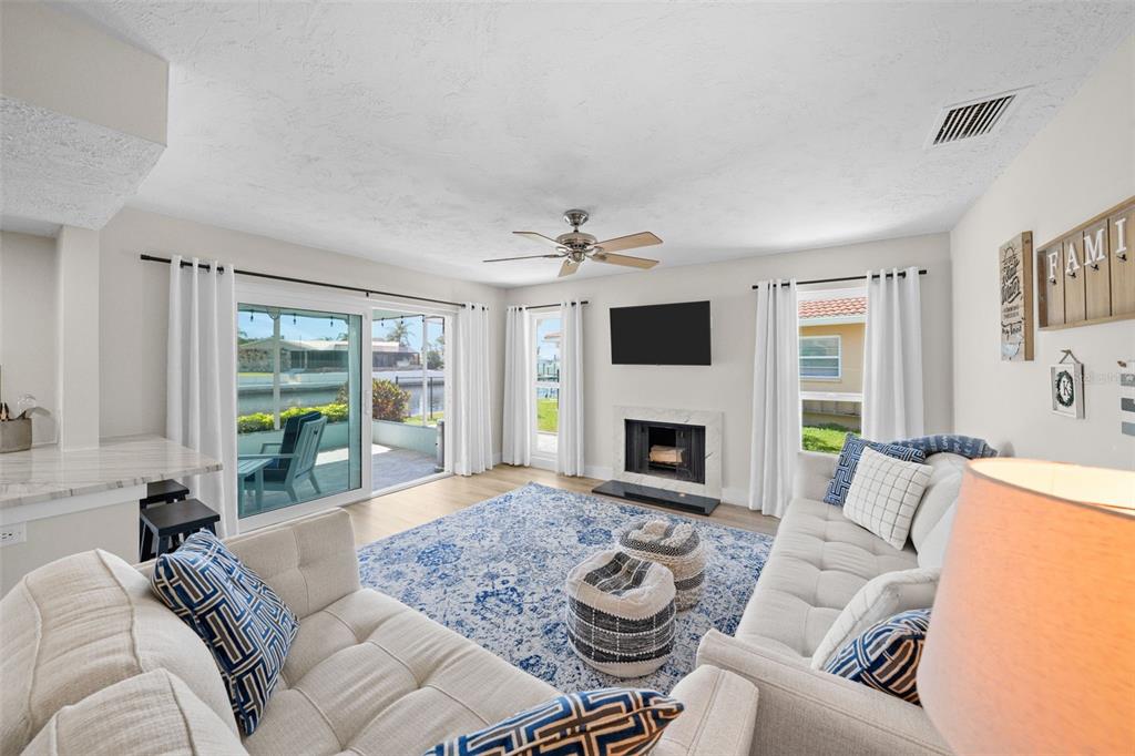 4968 South Shore Drive New Port Richey, FL 34652 - Photo 7 of 60 a living room with furniture and a fireplace