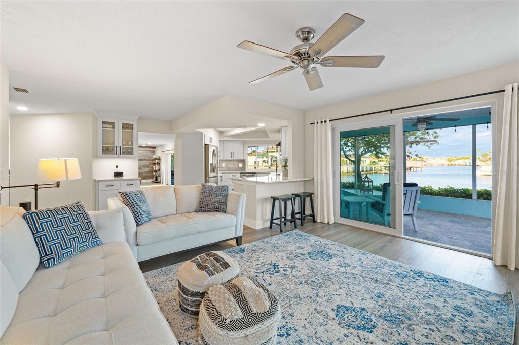 4968 South Shore Drive New Port Richey, FL 34652 - Photo 8 of 60 a living room with furniture and a large window with wooden floor