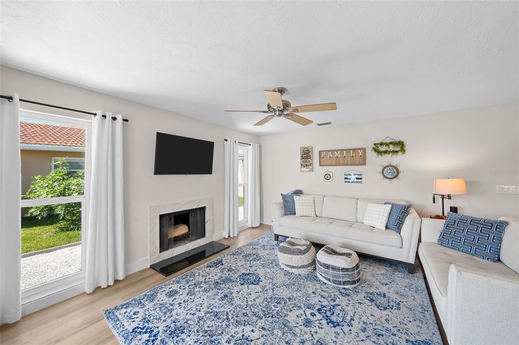 4968 South Shore Drive New Port Richey, FL 34652 - Photo 9 of 60 a living room with furniture and a fireplace