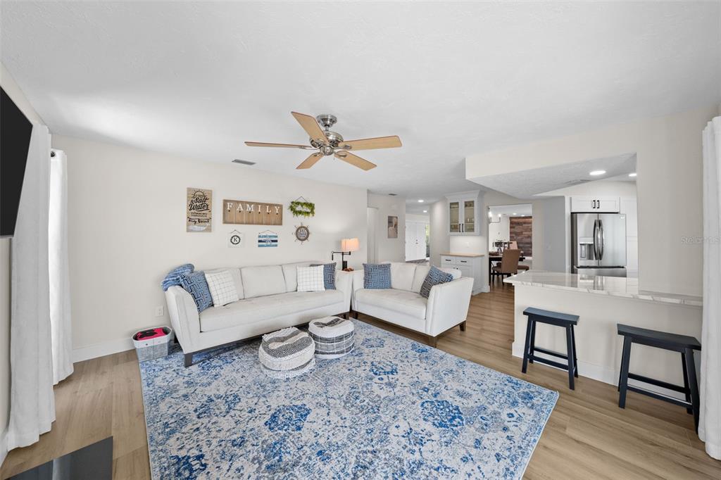 4968 South Shore Drive New Port Richey, FL 34652 - Photo 10 of 60 a living room with furniture or couch and a rug