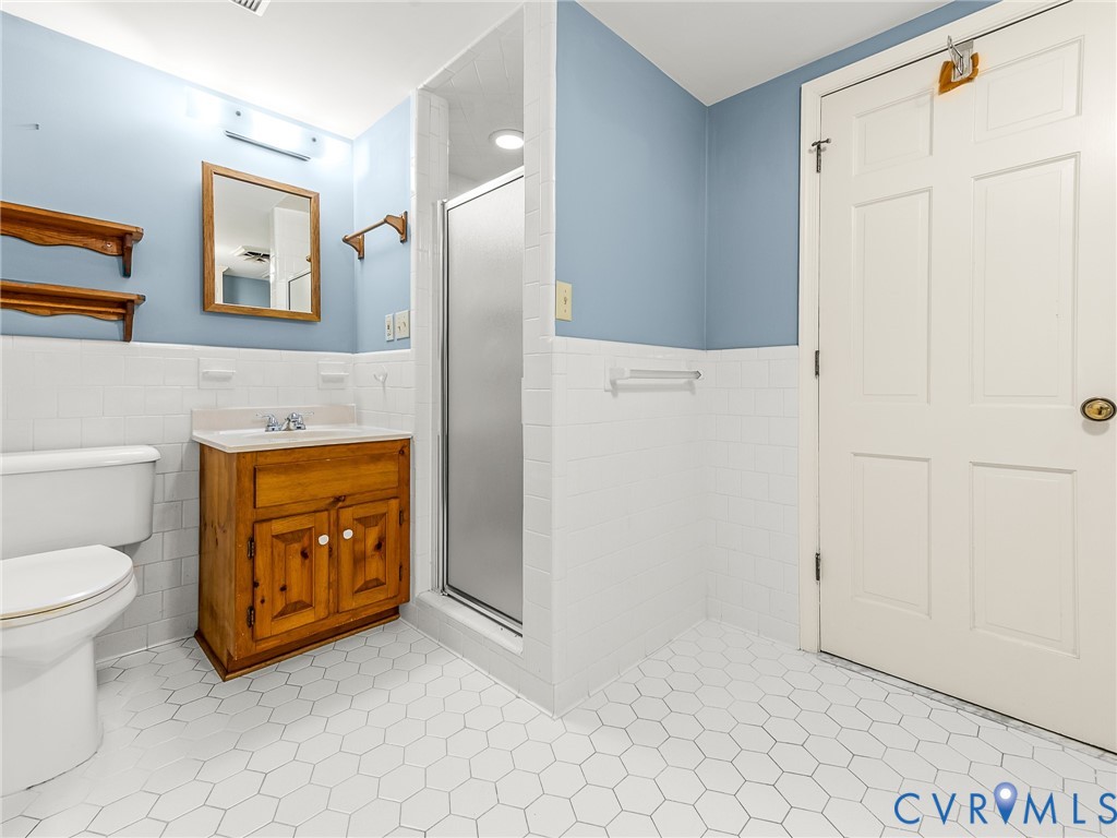12911 Percival Street Chester, VA 23831 - Photo 16 of 21 a bathroom with a sink a toilet and a mirror