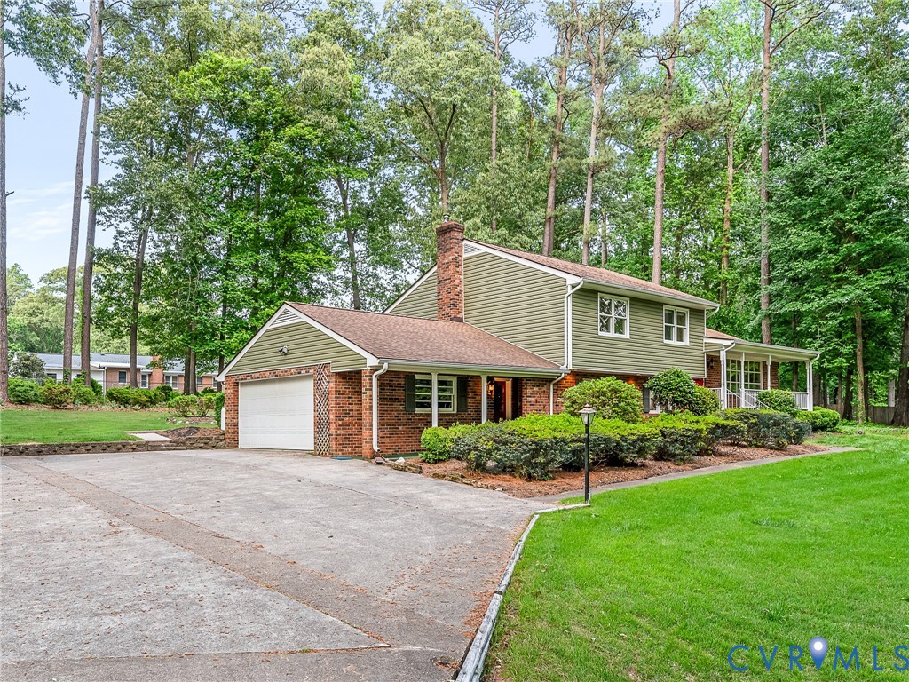 12911 Percival Street Chester, VA 23831 - Photo 18 of 21 a front view of a house with a garden and plants