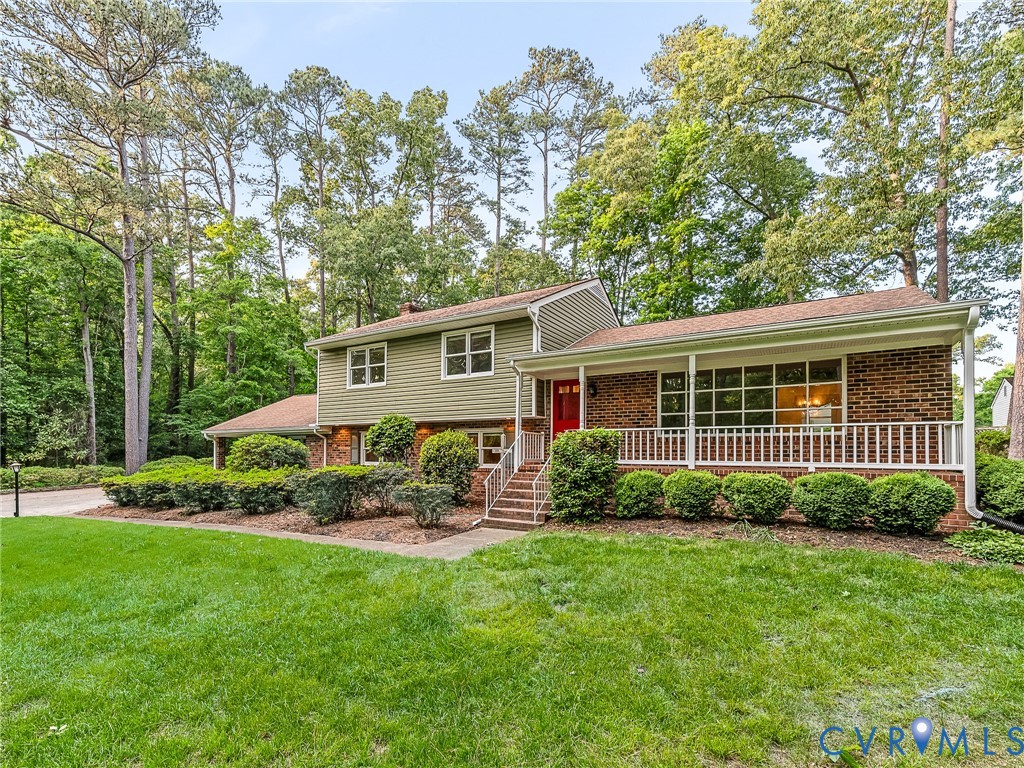 12911 Percival Street Chester, VA 23831 - Photo 2 of 21 a view of a house with backyard sitting area and garden