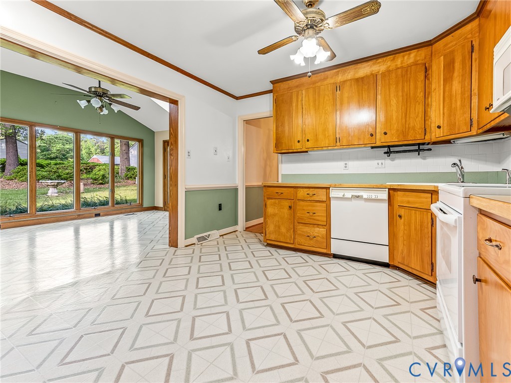12911 Percival Street Chester, VA 23831 - Photo 9 of 21 a view of a kitchen with kitchen island granite countertop a refrigerator a stove top oven cabinetry a sink and a large window