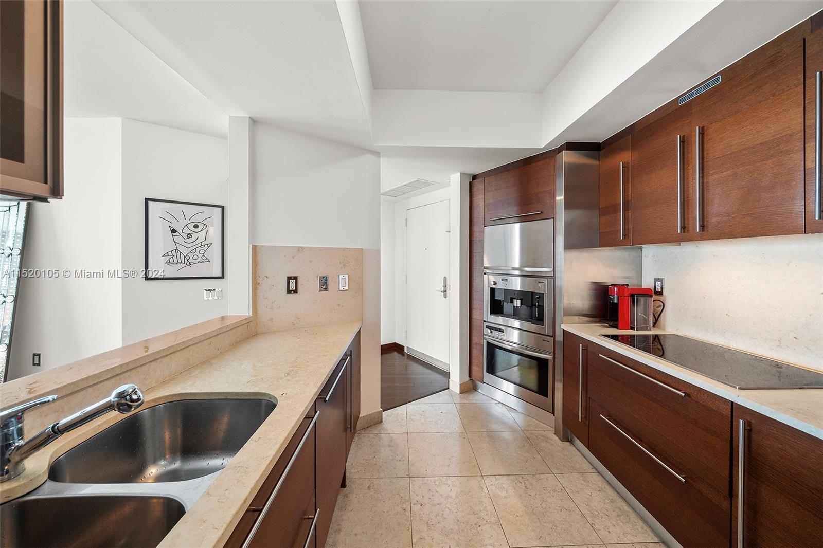 450 Alton Road, Unit 2006 Miami Beach, FL 33139 - Photo 13 of 51 a kitchen with stainless steel appliances granite countertop a sink stove and refrigerator