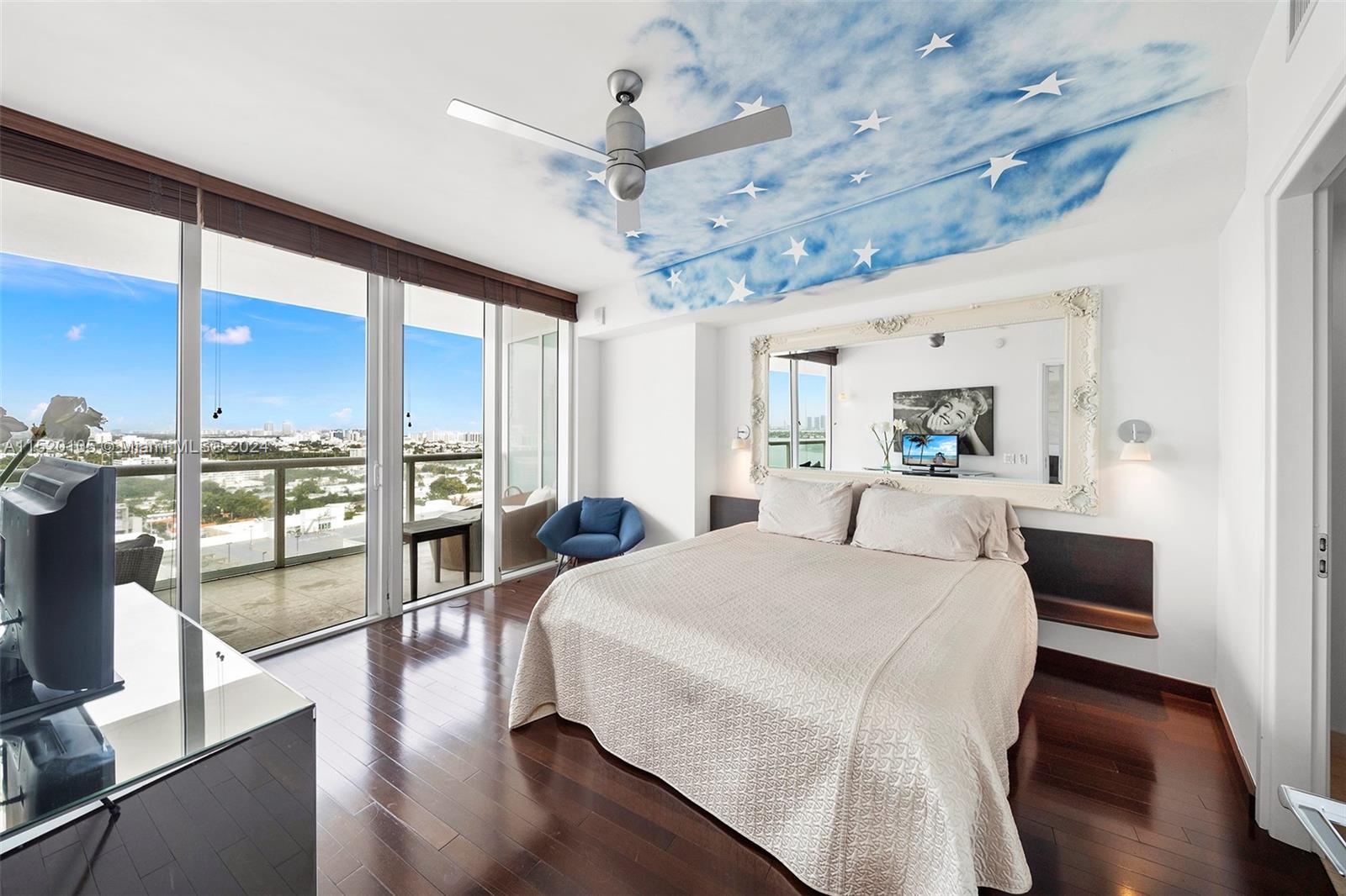 450 Alton Road, Unit 2006 Miami Beach, FL 33139 - Photo 14 of 51 a large room with a bed and glass windows