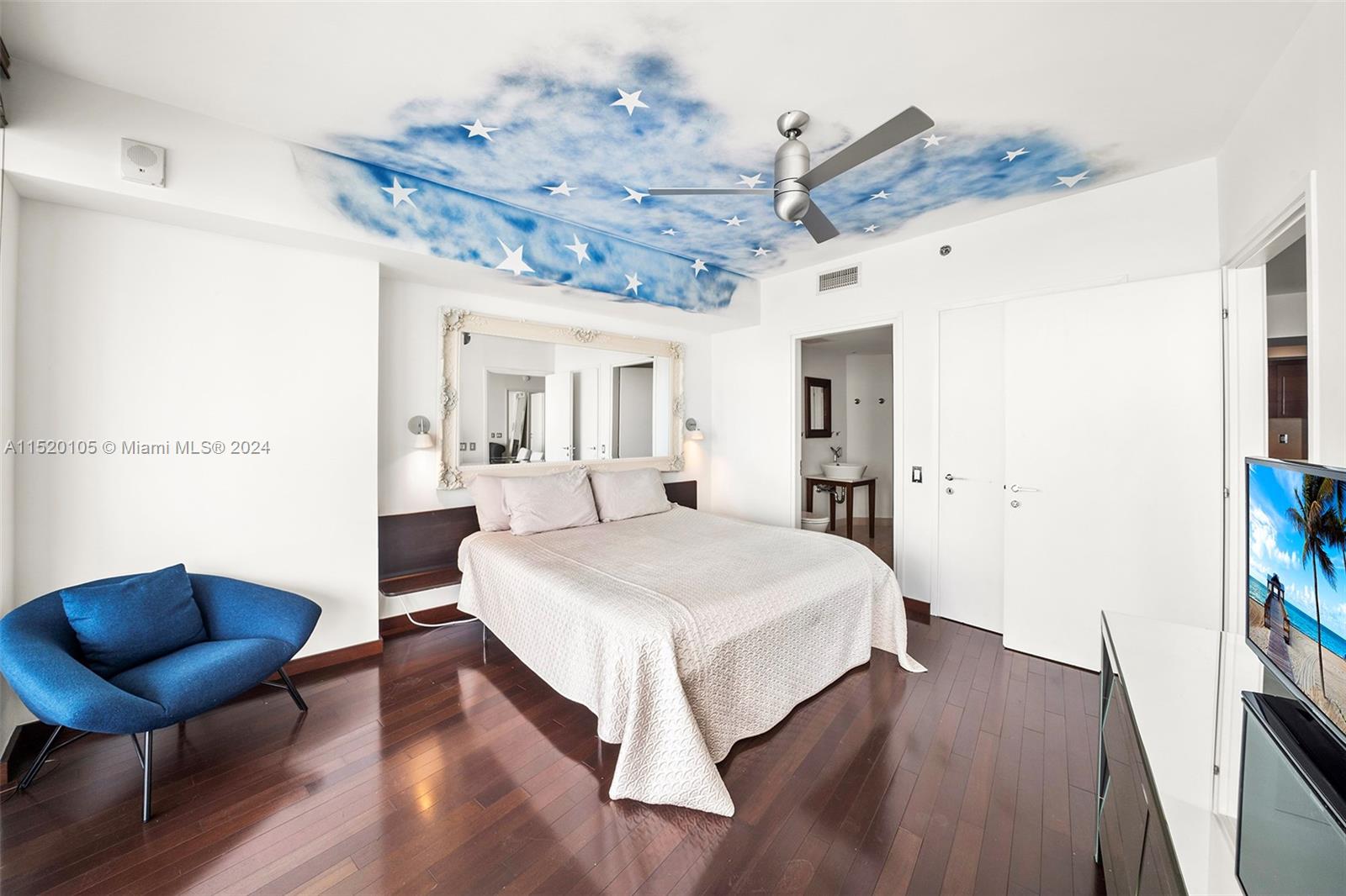 450 Alton Road, Unit 2006 Miami Beach, FL 33139 - Photo 16 of 51 a spacious bedroom with a bed and a chair with the potted plant