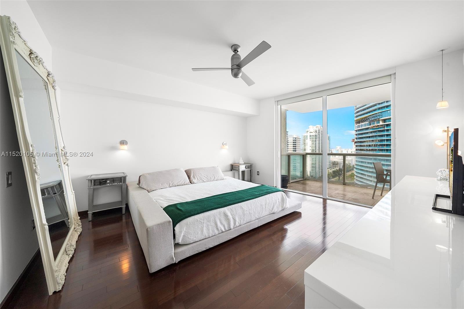 450 Alton Road, Unit 2006 Miami Beach, FL 33139 - Photo 18 of 51 a bedroom with a bed couch and a large window