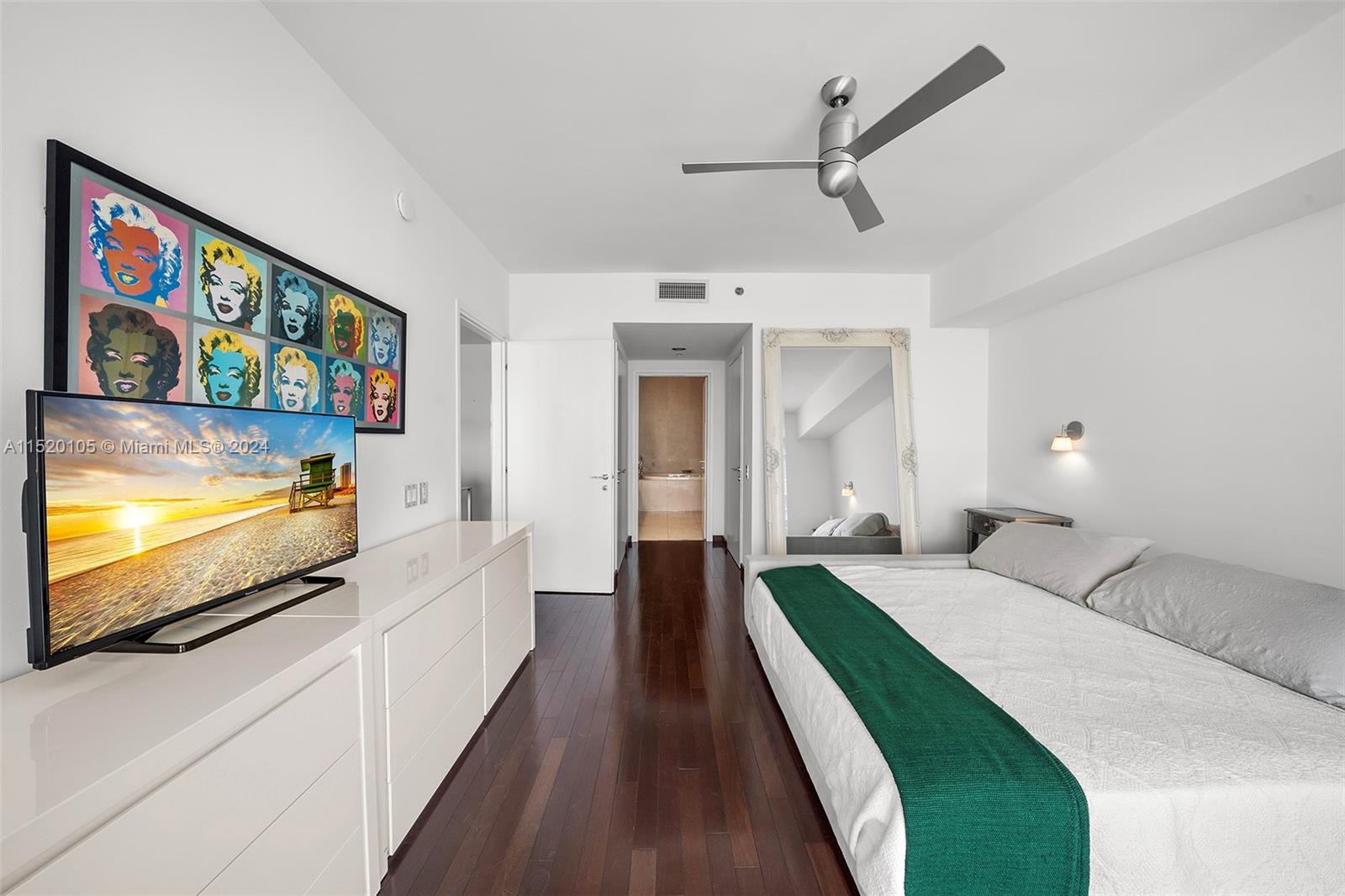 450 Alton Road, Unit 2006 Miami Beach, FL 33139 - Photo 20 of 51 a bedroom with furniture and a flat screen tv