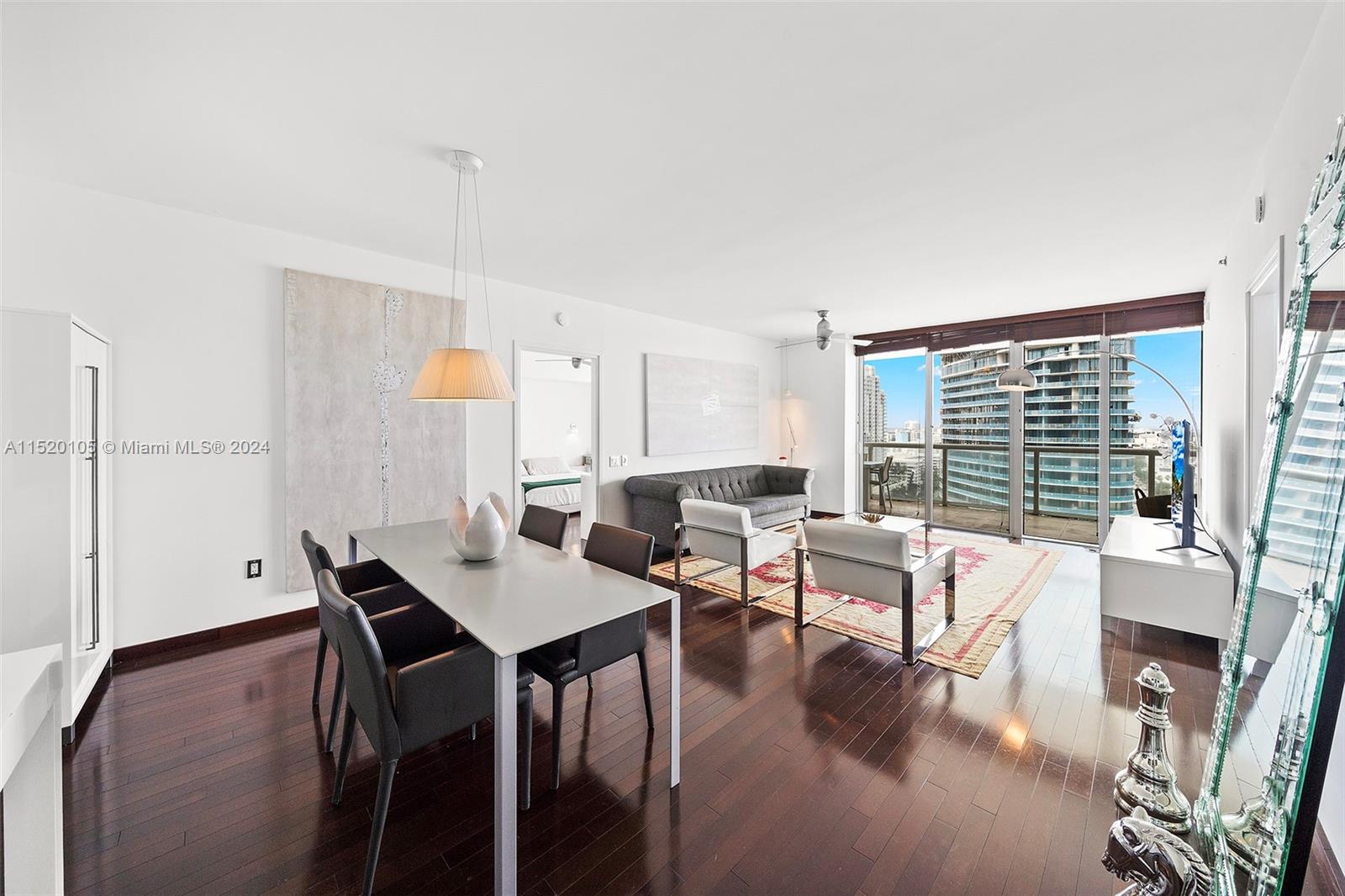 450 Alton Road, Unit 2006 Miami Beach, FL 33139 - Photo 2 of 51 a living room with furniture and a large window