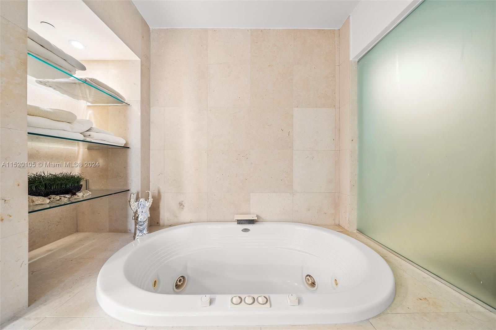 450 Alton Road, Unit 2006 Miami Beach, FL 33139 - Photo 23 of 51 a bathroom with bathtub and shower