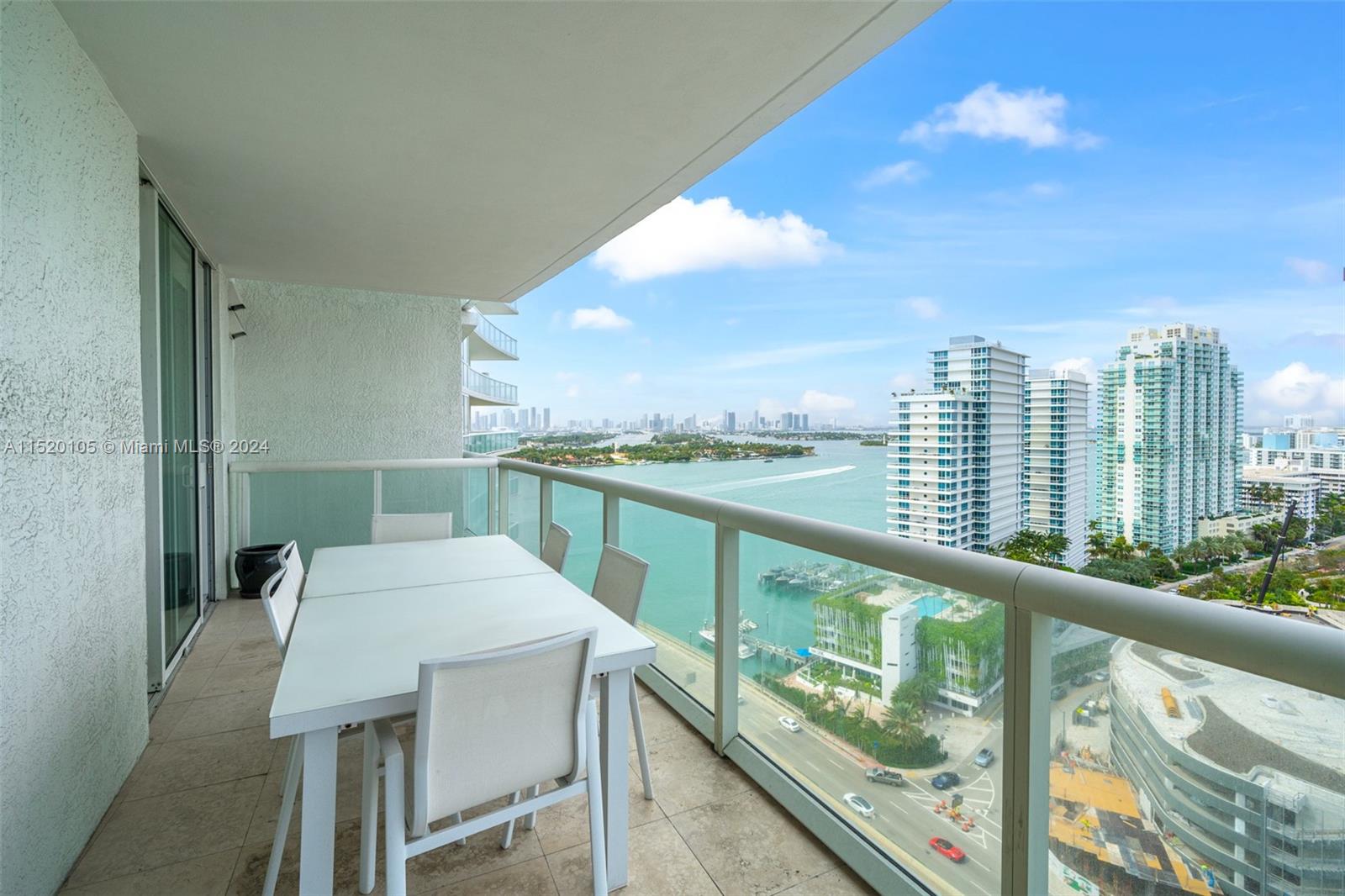 450 Alton Road, Unit 2006 Miami Beach, FL 33139 - Photo 27 of 51 a view of a balcony with table and chairs