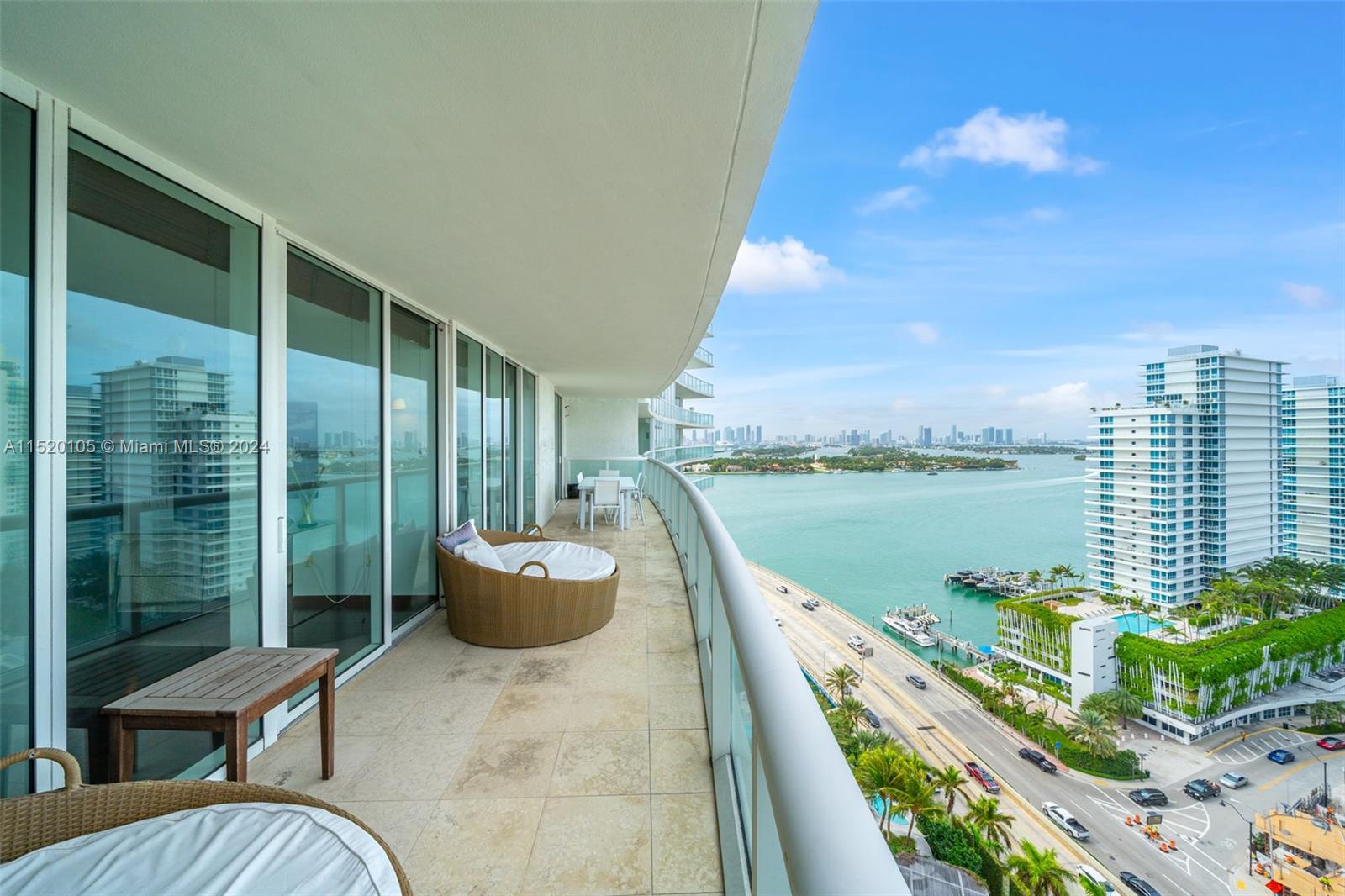 450 Alton Road, Unit 2006 Miami Beach, FL 33139 - Photo 29 of 51 a balcony with couch and lake view