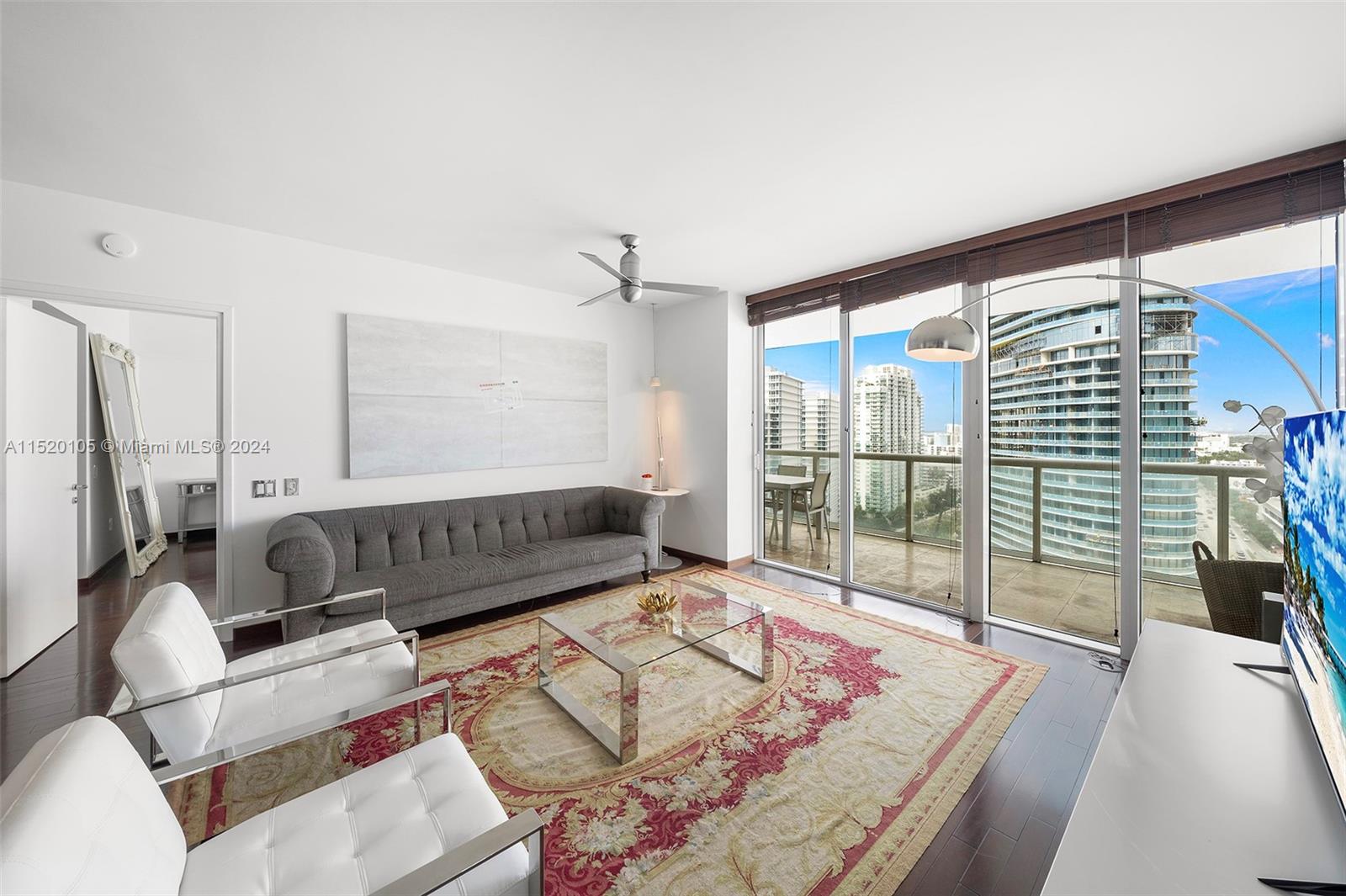 450 Alton Road, Unit 2006 Miami Beach, FL 33139 - Photo 9 of 51 a living room with furniture and a floor to ceiling window