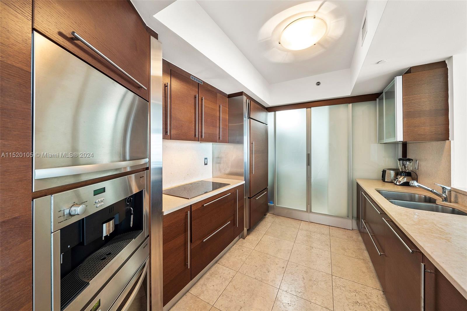 450 Alton Road, Unit 2006 Miami Beach, FL 33139 - Photo 10 of 51 a kitchen with stainless steel appliances granite countertop a sink stove and refrigerator