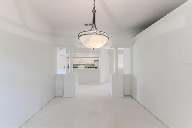 a large white kitchen with a large window