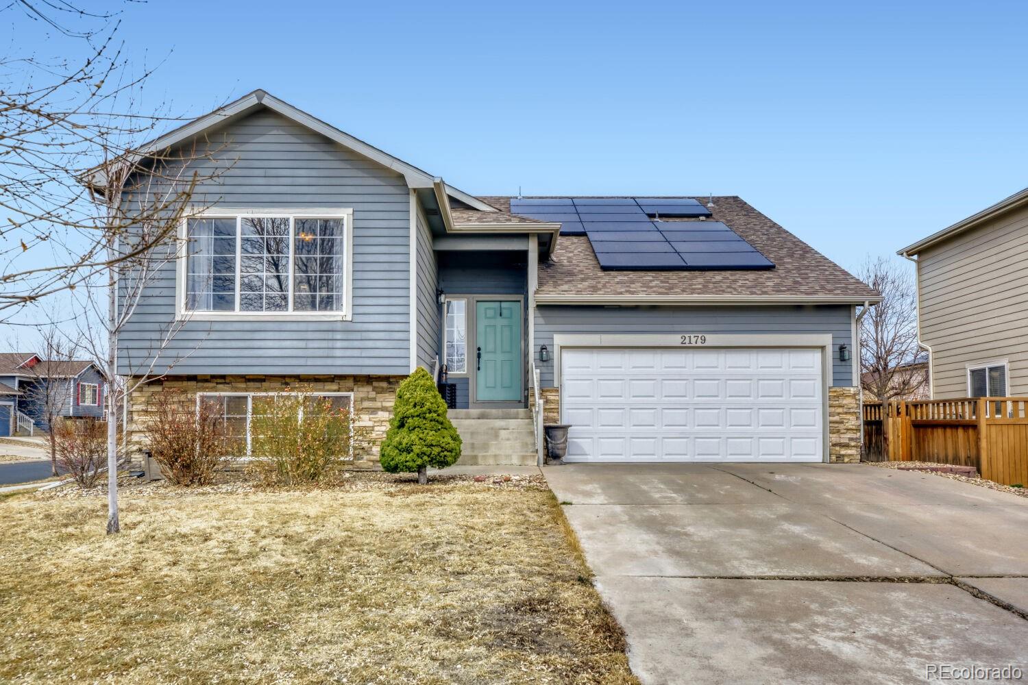 2179 Fletcher Avenue Brighton, CO 80603 - Photo 1 of 29 a front view of a house with a yard and garage
