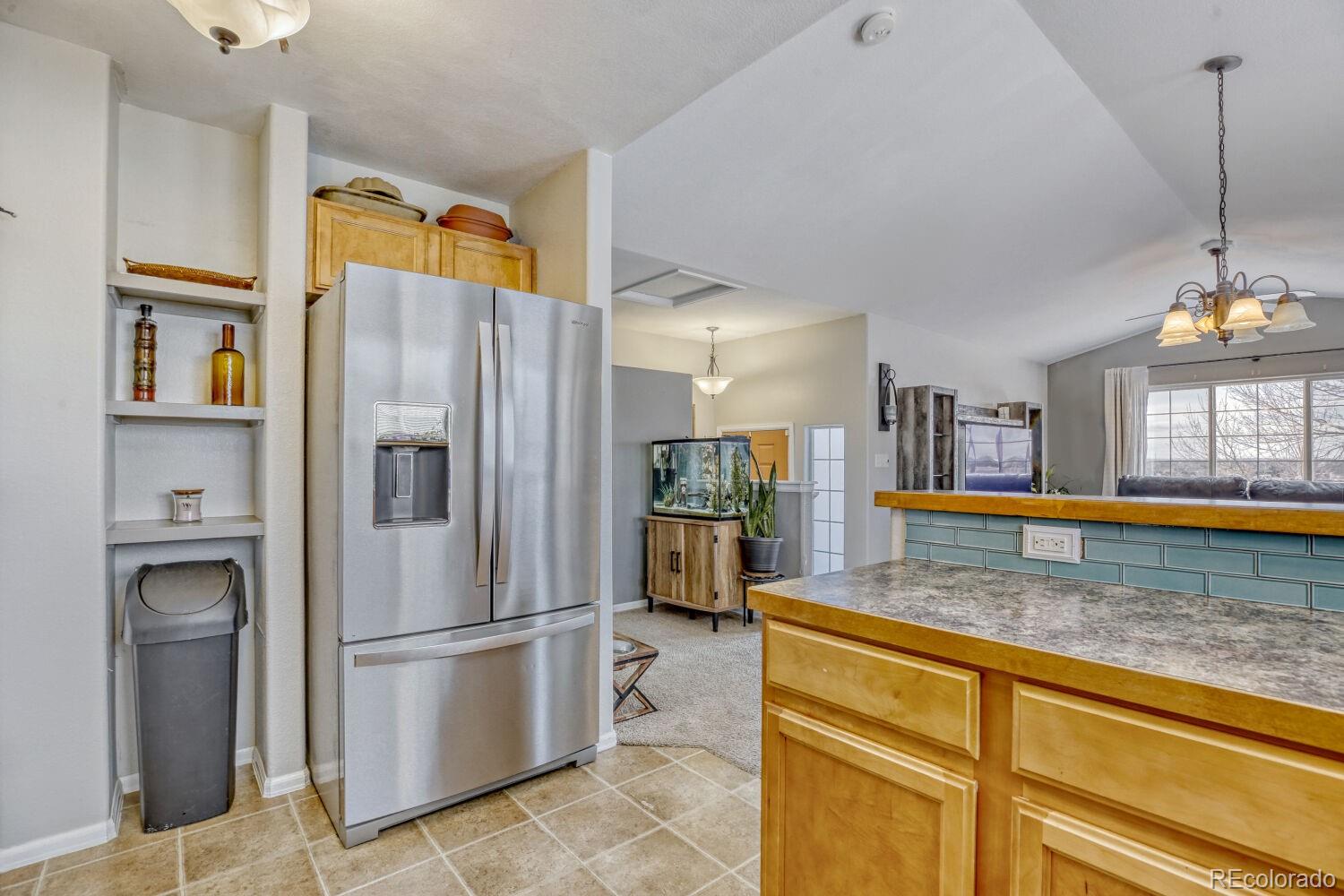 2179 Fletcher Avenue Brighton, CO 80603 - Photo 12 of 29 a kitchen with stainless steel appliances granite countertop a refrigerator a stove and a sink