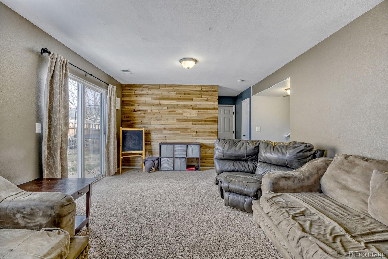 2179 Fletcher Avenue Brighton, CO 80603 - Photo 14 of 29 a living room with furniture and a large window