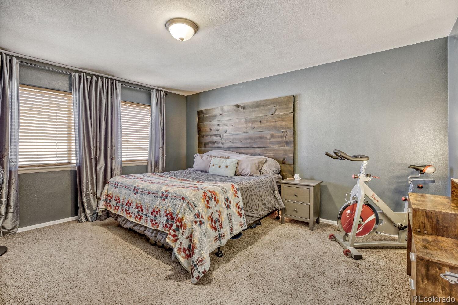 2179 Fletcher Avenue Brighton, CO 80603 - Photo 15 of 29 a bedroom with a bed and a window