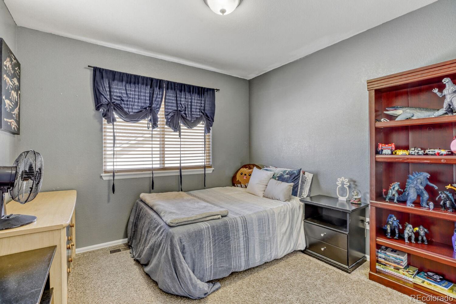 2179 Fletcher Avenue Brighton, CO 80603 - Photo 19 of 29 a bedroom with a bed and dresser