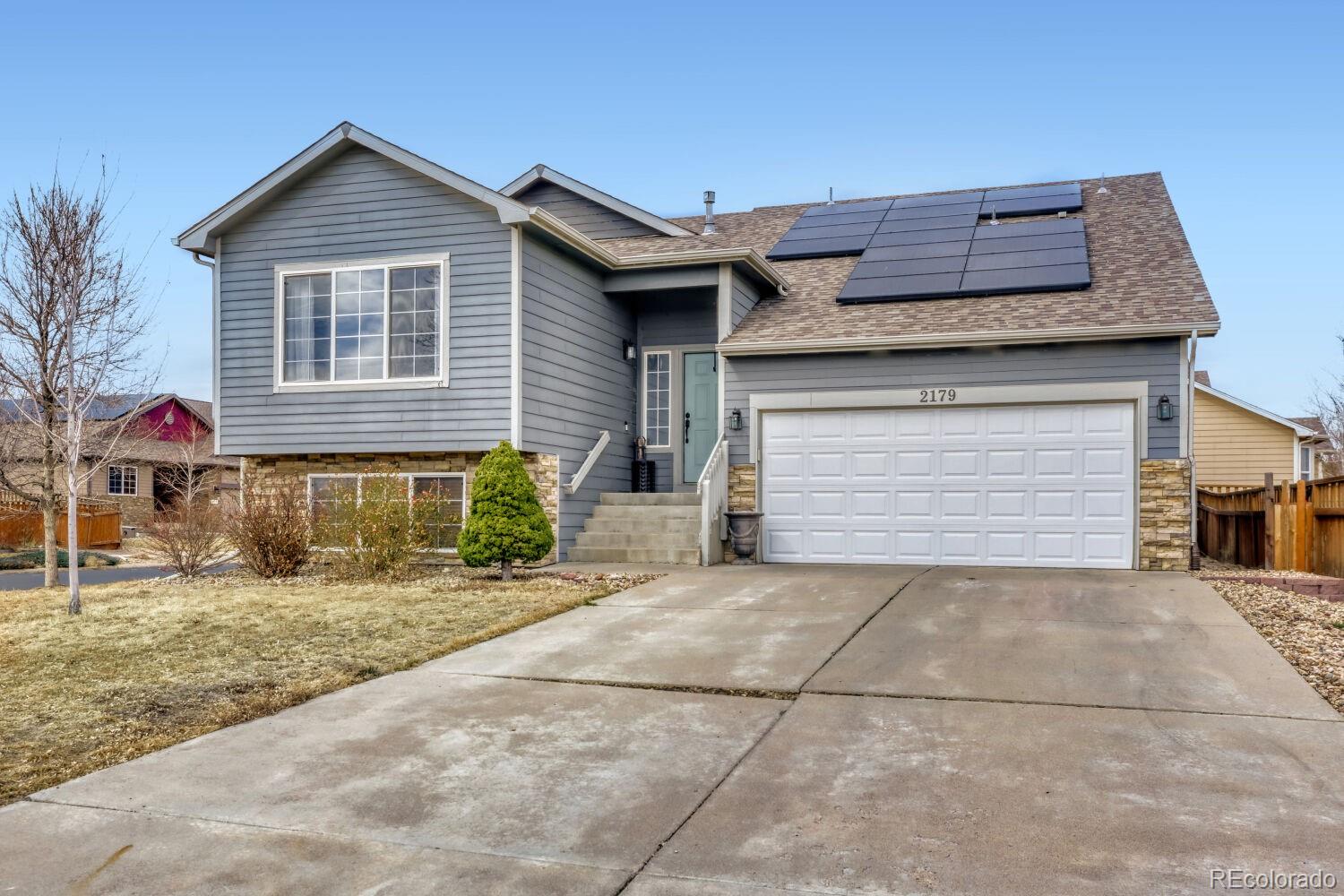 2179 Fletcher Avenue Brighton, CO 80603 - Photo 2 of 29 a front view of a house with a yard and garage