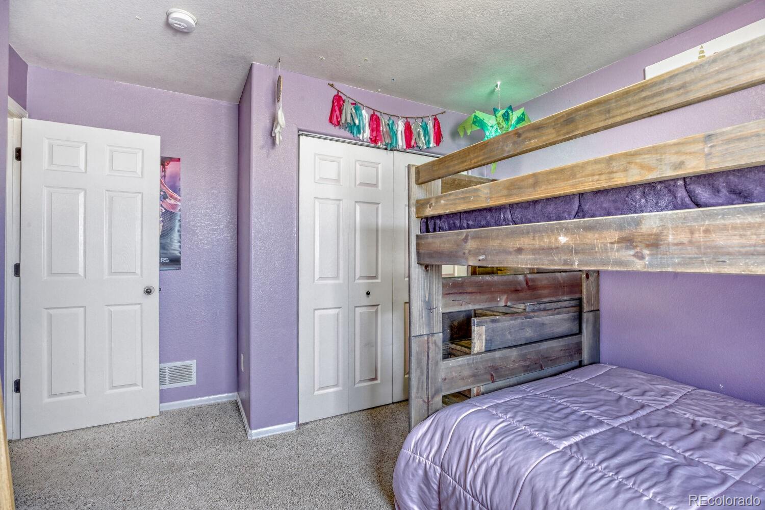 2179 Fletcher Avenue Brighton, CO 80603 - Photo 22 of 29 a bedroom with a bed and a walk in closet