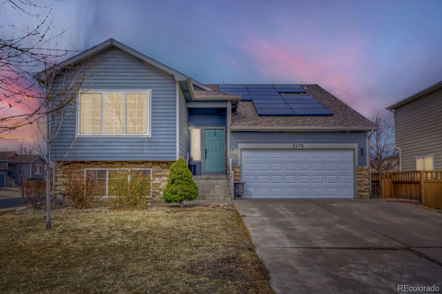 2179 Fletcher Avenue Brighton, CO 80603 - Photo 29 of 29 a front view of a house with a yard and garage