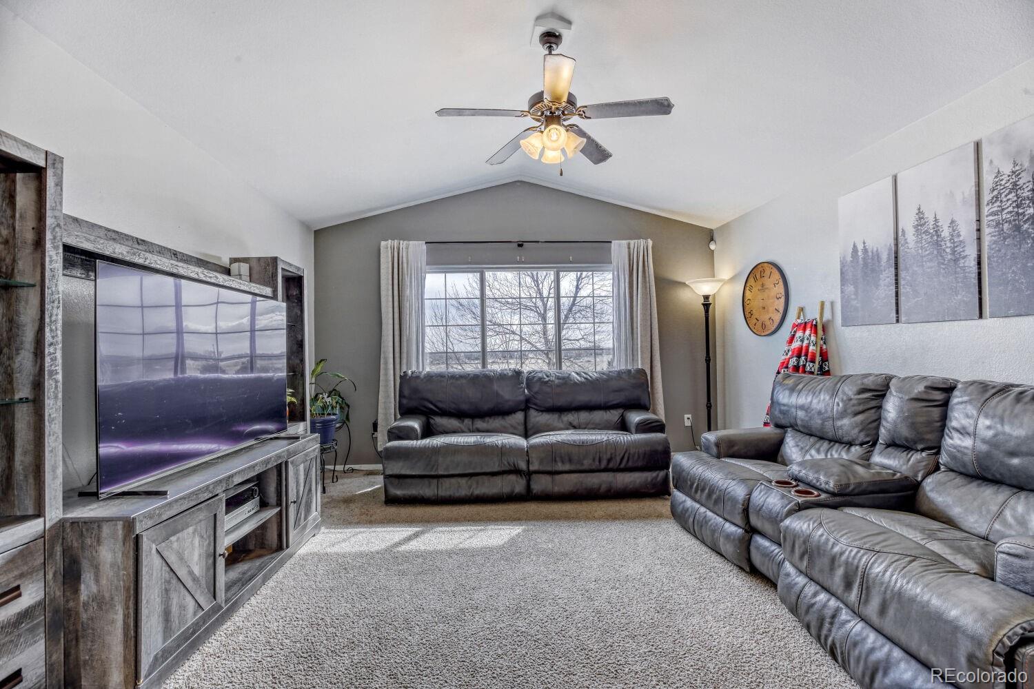 2179 Fletcher Avenue Brighton, CO 80603 - Photo 4 of 29 a living room with furniture and a flat screen tv