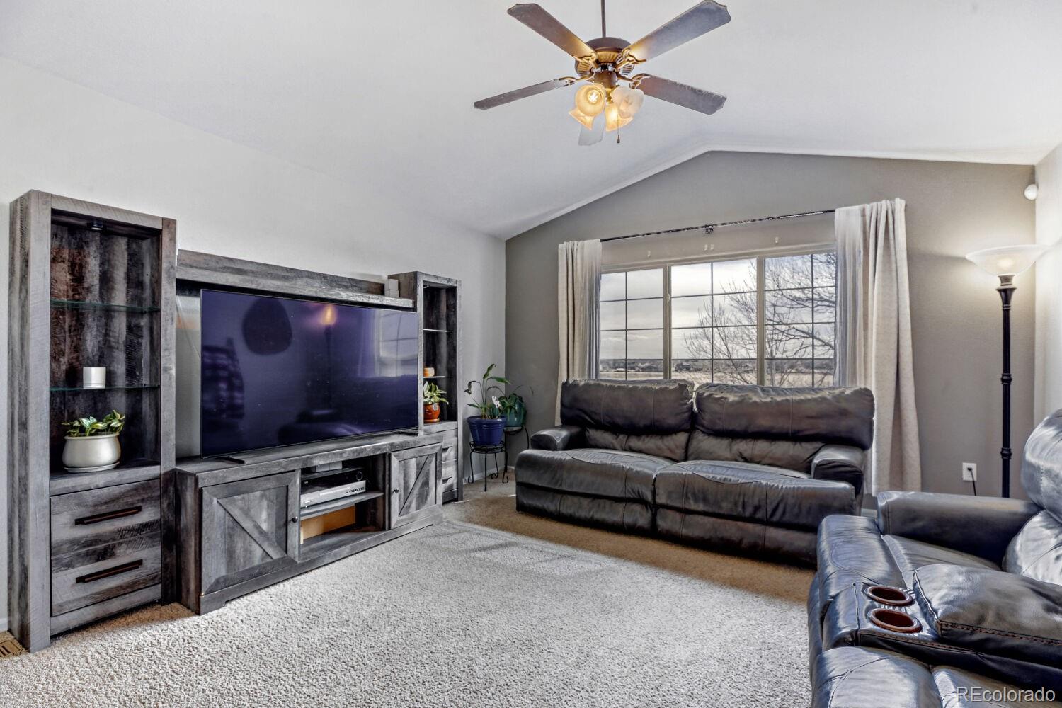 2179 Fletcher Avenue Brighton, CO 80603 - Photo 6 of 29 a living room with furniture and a flat screen tv