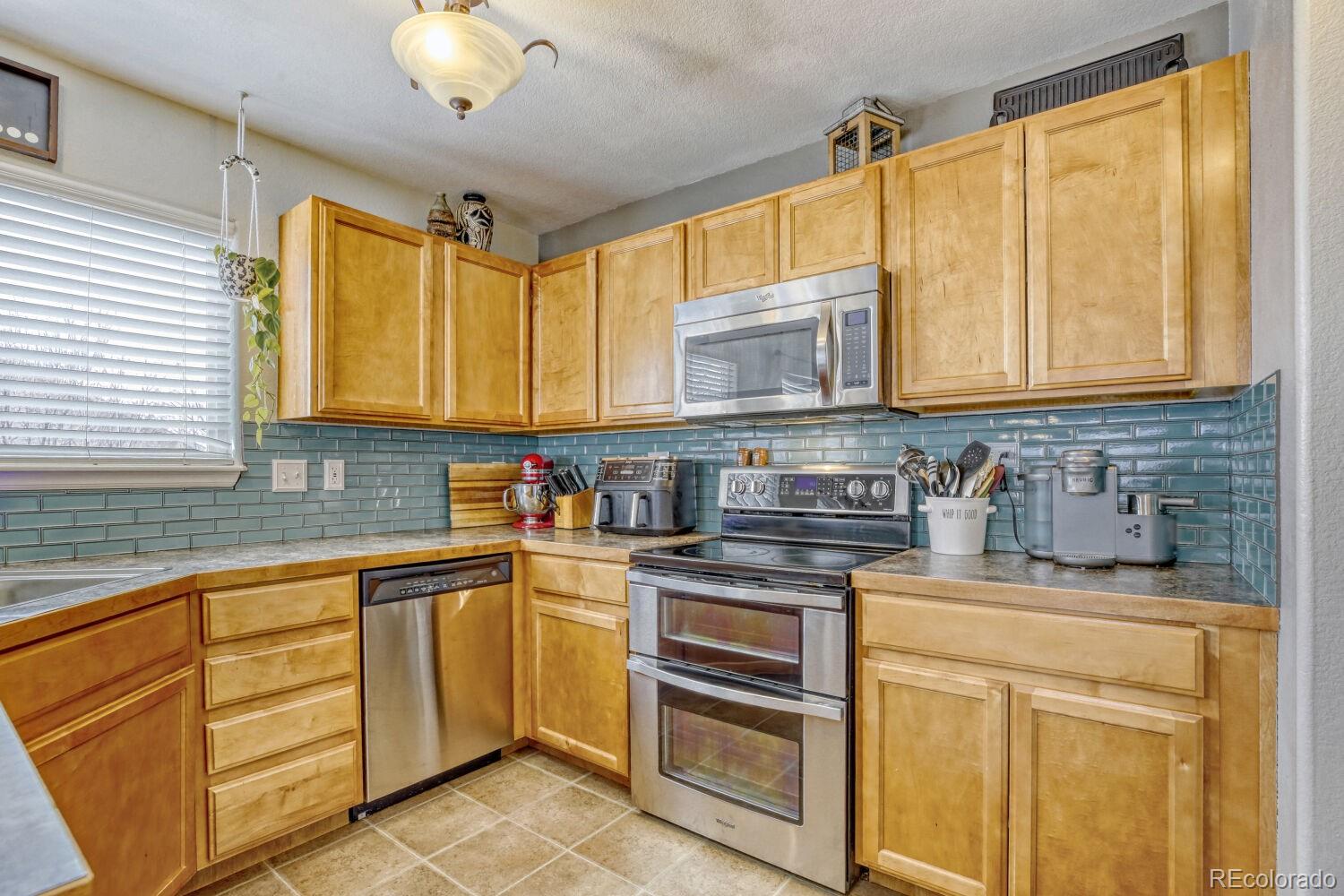 2179 Fletcher Avenue Brighton, CO 80603 - Photo 10 of 29 a kitchen with stainless steel appliances granite countertop a sink and cabinets