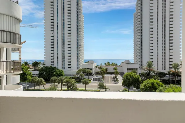 a view of a balcony with wooden floor and fence