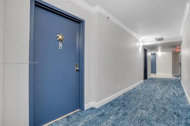 a room with furniture pool table and paintings on the wall