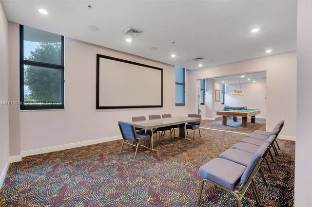 a view of a patio with a table and chairs under an umbrella