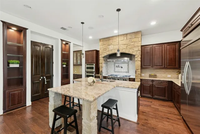 a bathroom with a granite countertop sink toilet a large mirror and shower